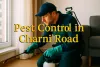 Pest control technician spraying near window in Charni Road apartment with bold highlighted service text.