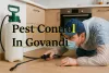 Pest control worker treating cockroach in Govandi kitchen with bold shadowed text and protective mask.