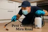 Pest control technician spraying cockroach in modern Mira Road kitchen with gloves, mask, and shadowed Lora font text.