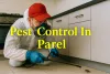Pest control expert spraying cockroach in Parel kitchen with bold yellow highlighted text and safety gear.